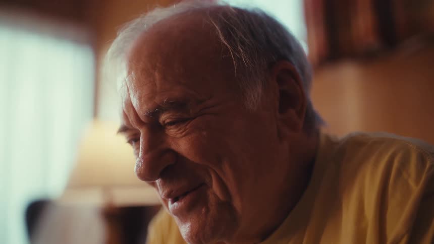 A man smiles and laughs