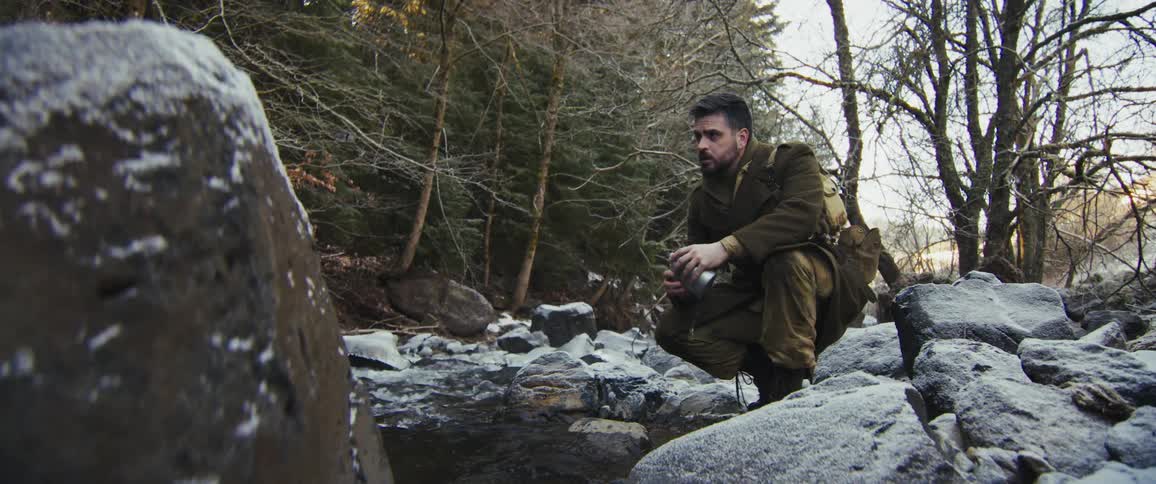 Soldier fetching water from a stream
