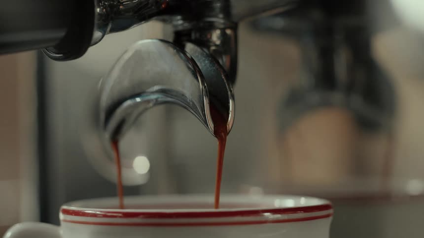 A close up of an espresso machine making coffee