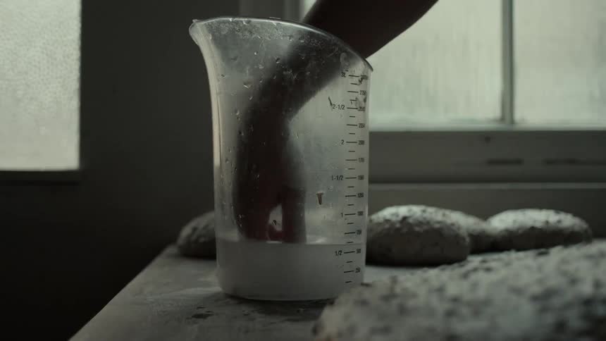 A person rolling balls of dough