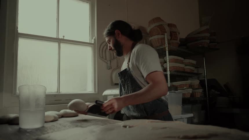 Man in apron preparing bread dough