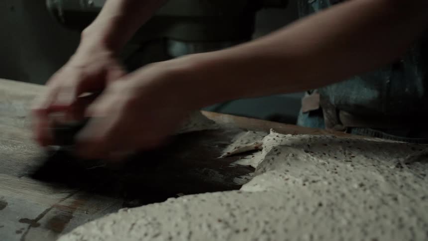 Person cutting bread dough