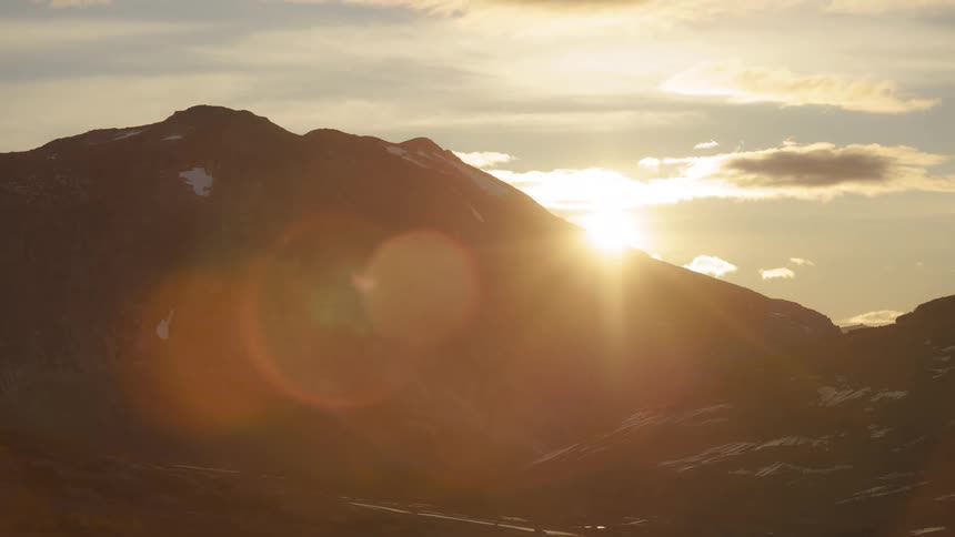 The sun sets behind the mountain