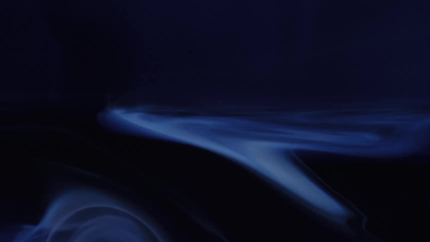A dark atmospheric abstract scene shows flowing smokelike blue light curves sweeping diagonally across a deep navy background creating a cinematic sense of motion and depth