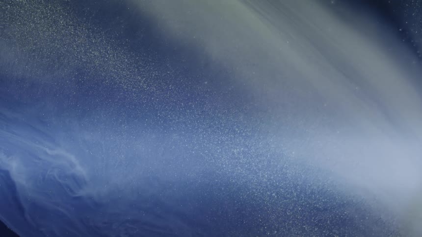 A dynamic blue liquid splash effect that resembles outer space with swirling motion and fine stardustlike particles shimmering through it