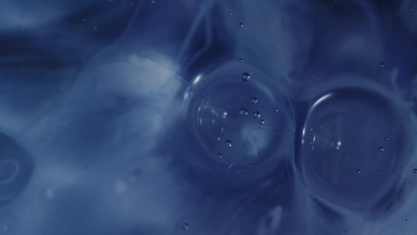 Drops splash into the blue paint