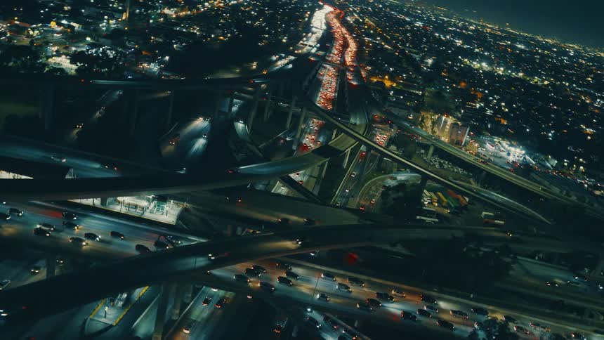 Heavy traffic on a stack interchange in a metropolitan area outdoors during night time