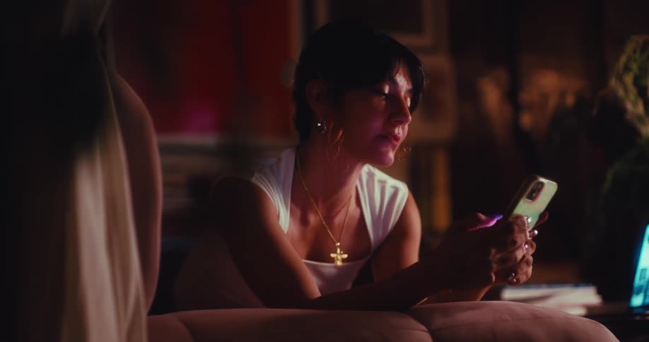 Woman holds her phone with both hands as she is texting