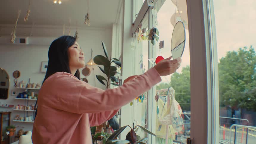 A woman opening up a store