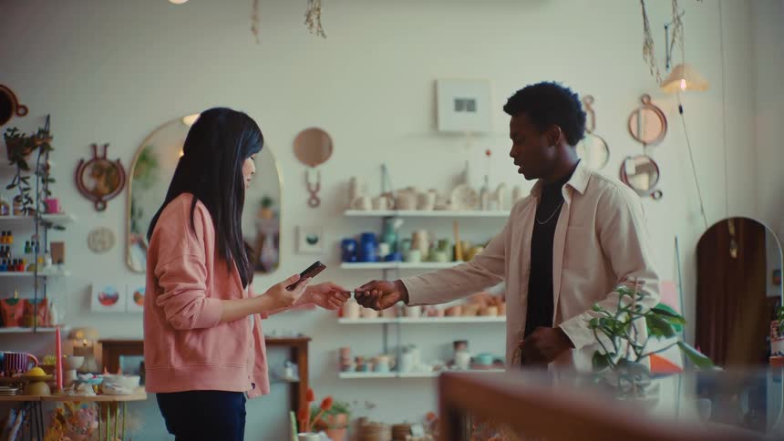 Small business owner completes a friendly customer purchase