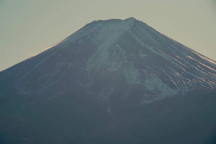 Sunlight shines upon snow on a mountain slopes