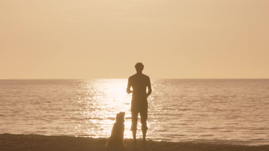 A man standing outdoors with his dog