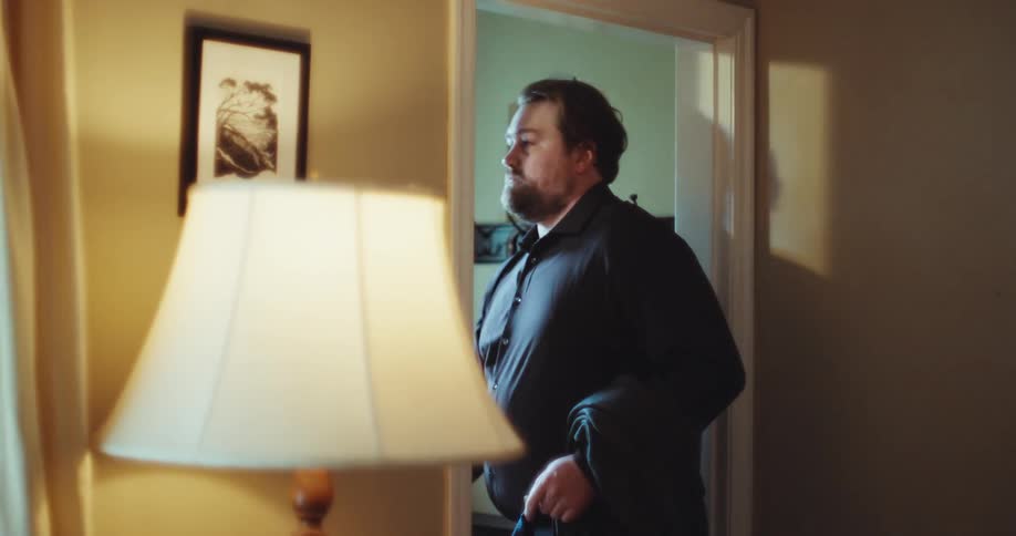 The man exits the home