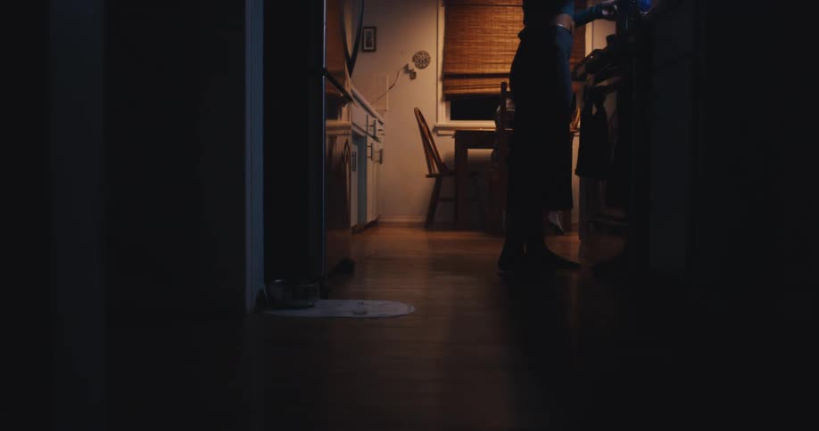 Family gathering and sitting at a table in the kitchen at night