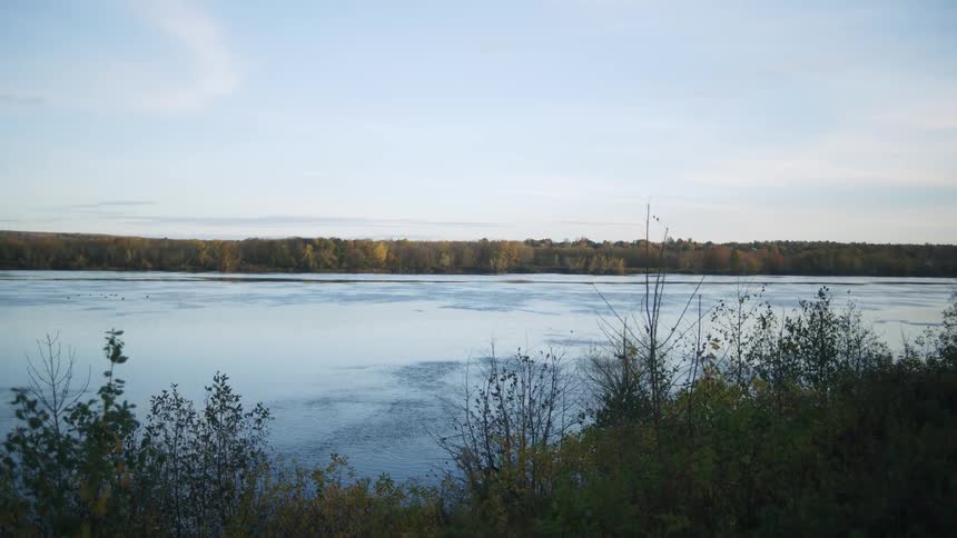 A view of a lake with some trees along the banks