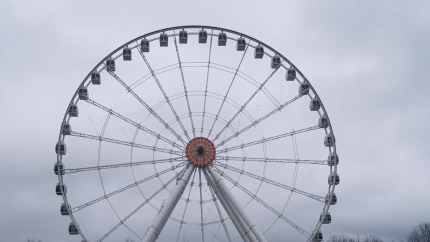 Ferris wheel against cloudy sky