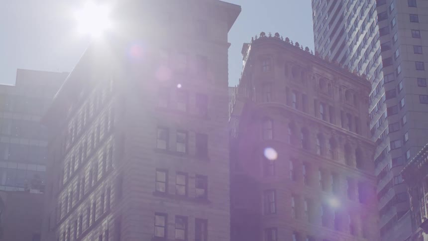 The cars turn the corner on the road in the big city