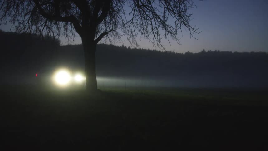 A car driving on a field at night