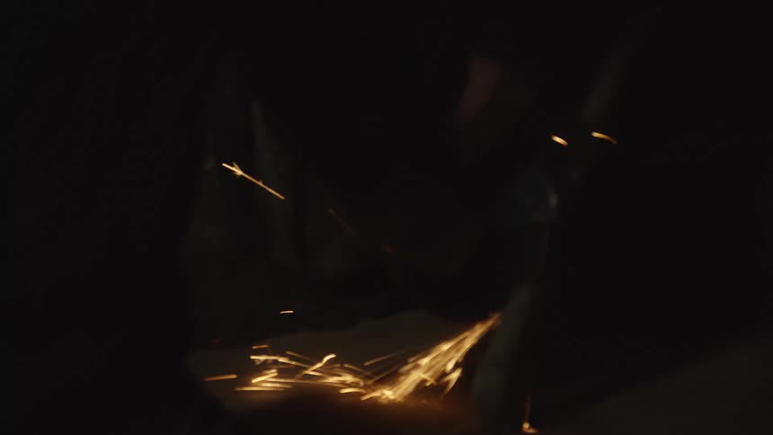 A man cutting a pipe with a grinder