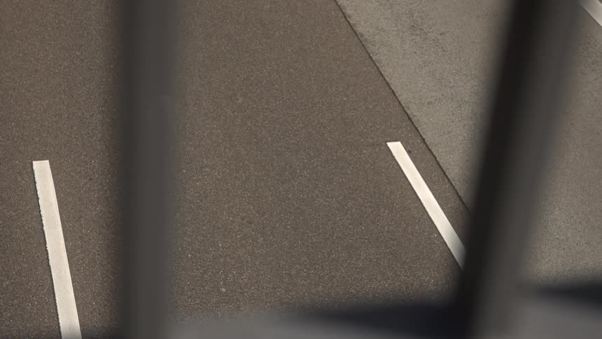 The trucks pass by under the overpass