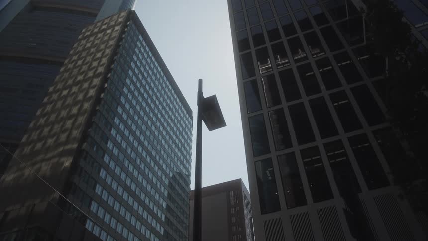 Lamp pole downtown with towers and skyscrapers in the distance