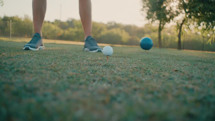 A person hitting a golf ball