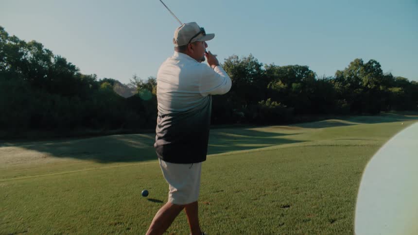 Player hits a golf ball with a swing and observes its trajectory