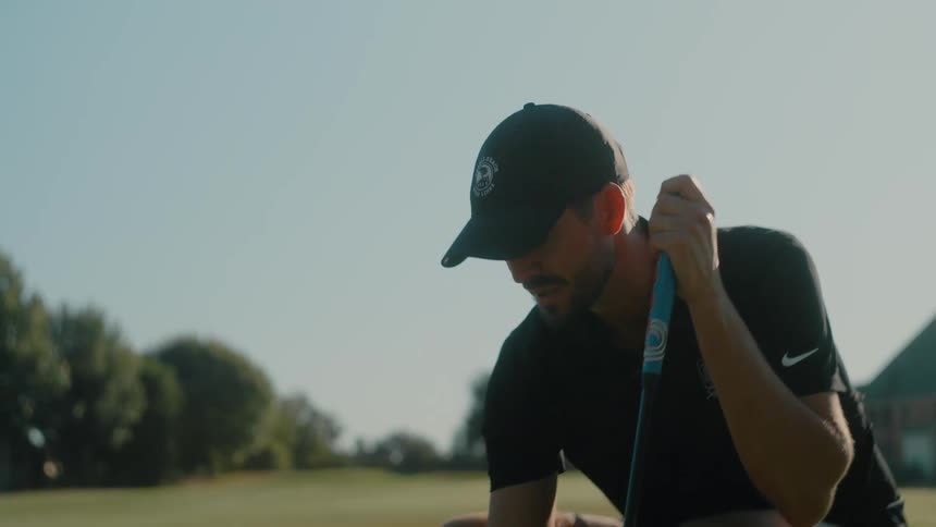 A young man playing golf