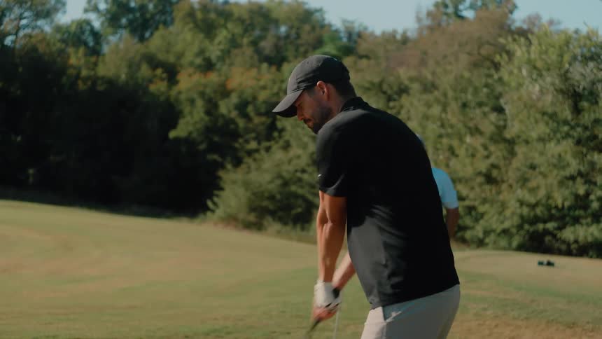 Two men golfing outdoors