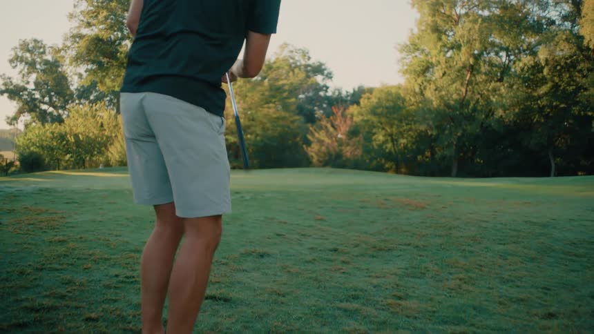 A young man playing golf