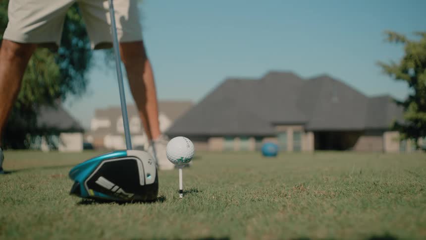 Player hitting a golf ball with a swing