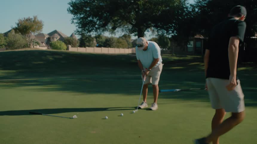 Man positioning a flag at a golf game