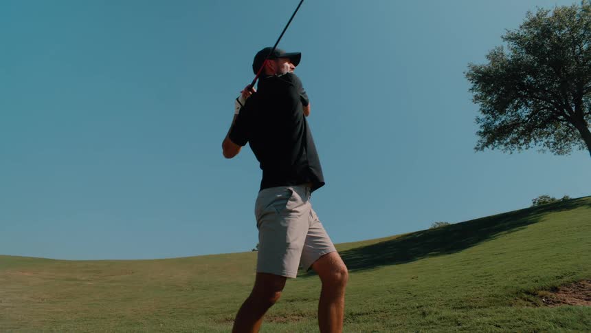 Man playing golf outdoors