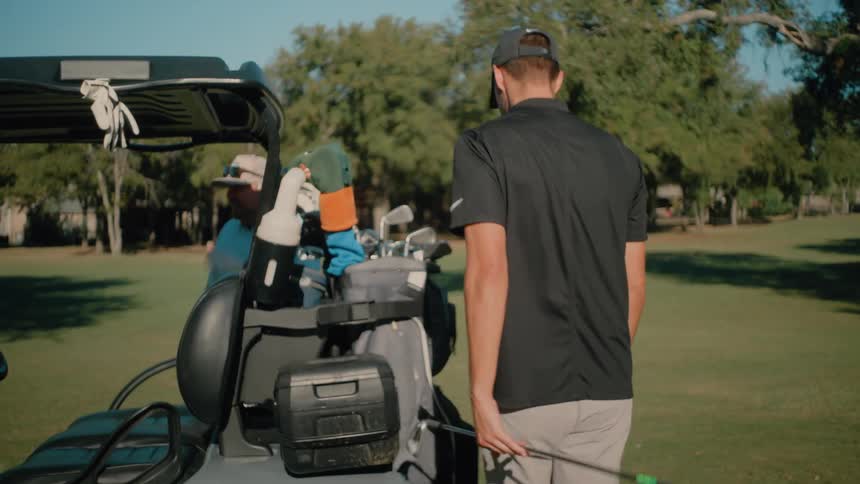 A couple guys playing golf