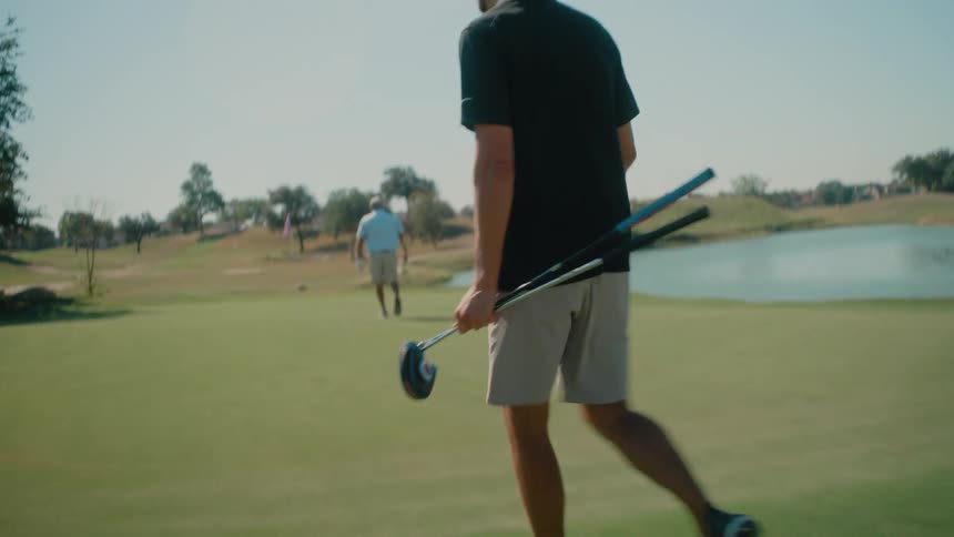 A couple men playing golf