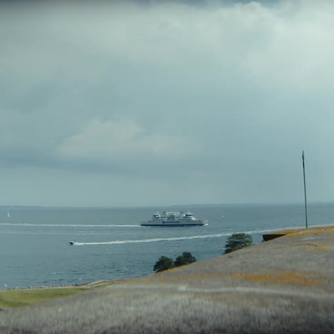Cruise ship sailing on the ocean near the coast outdoors during day time