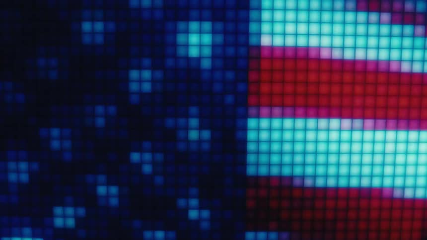 A digital american flag gradually comes into focus on a glowing led pixel display as the camera zooms out revealing the red and white stripes alongside the blue field and white stars through a grid of illuminated square light tiles