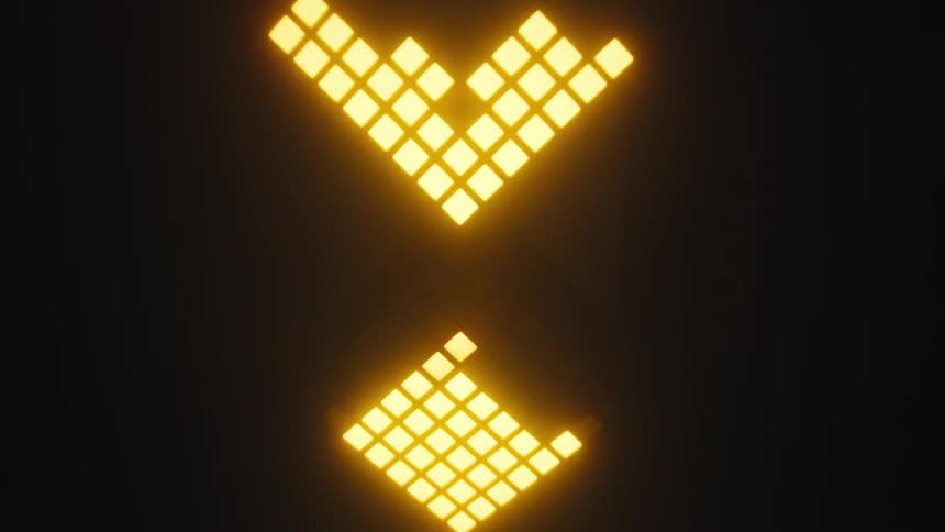 Yellow illuminated arrows pointing downward on a dark panel
