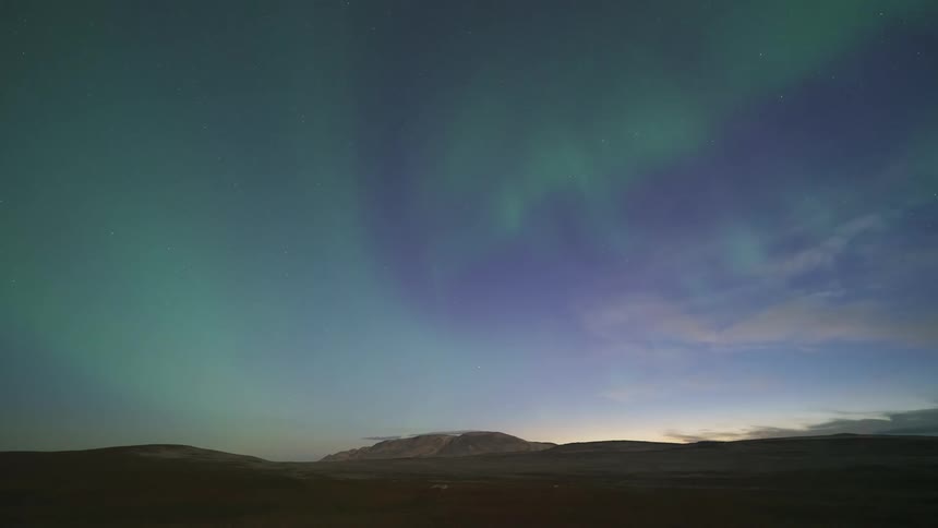 The green northern lights spin in the sky