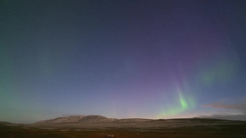 The green aurora shines in the sky