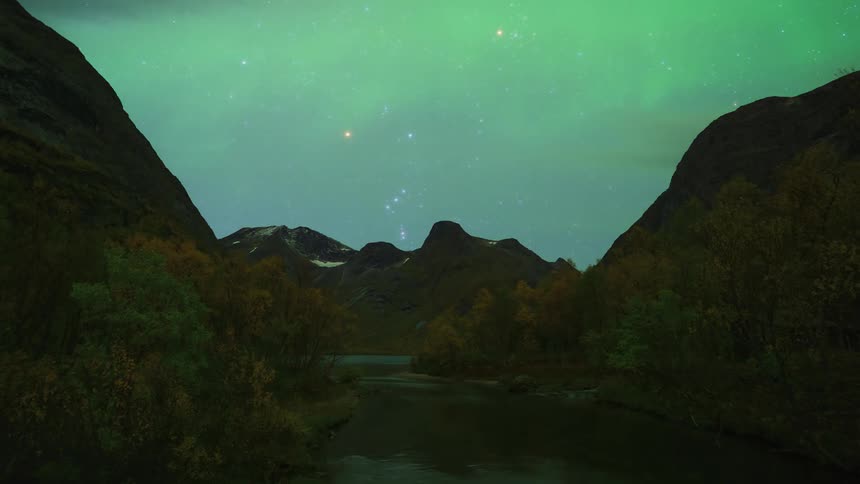 The glowing green lights of the aurora borealis move over a mountain river valley in a starry sky until morning and the sky is filled with clouds