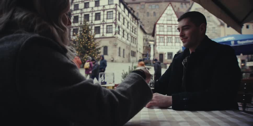 The couple are having beers outside the restaurant