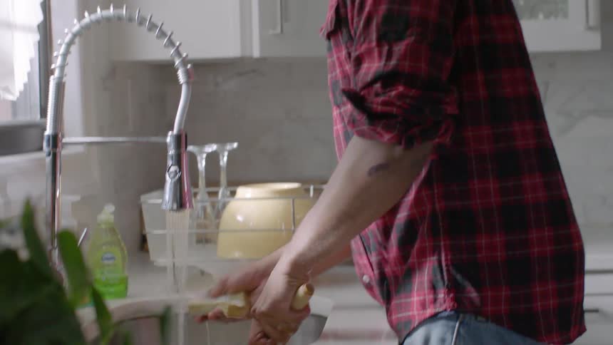 A man washes dishes