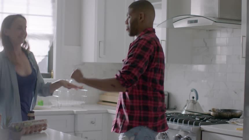 Woman and man dancing in the kitchen