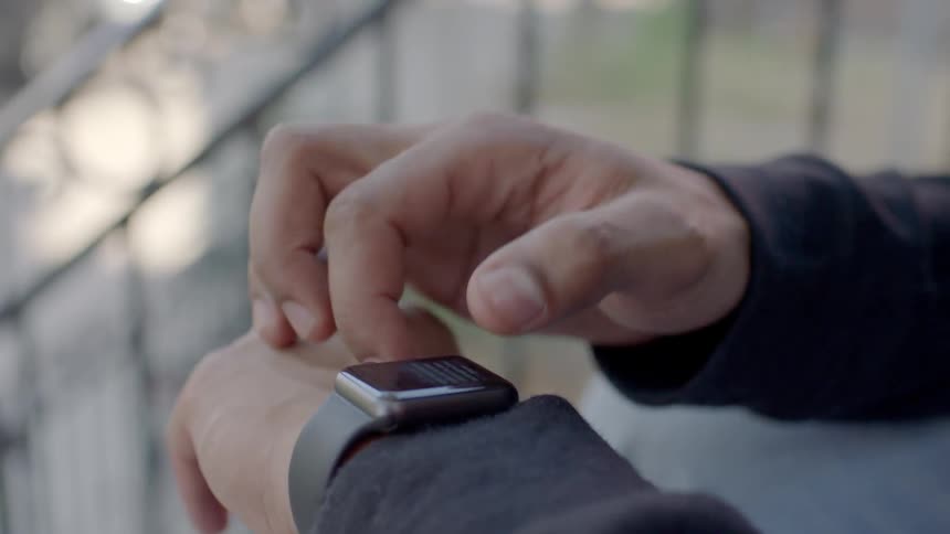 A man taps on his smart watch