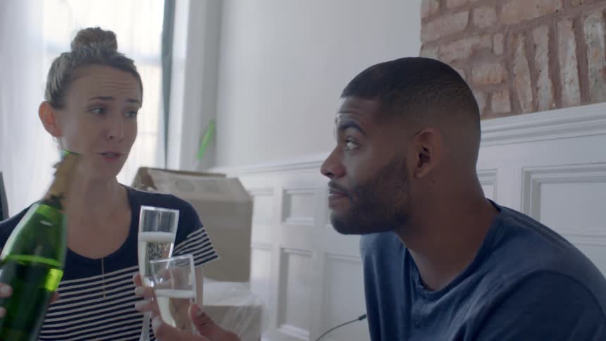 Two people sit and have a drink