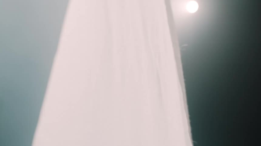 Translucent white curtain illuminated by soft light in an indoor setting