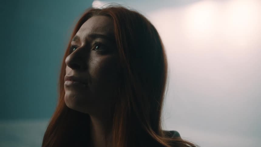 Young adult woman with a sad face expression indoors