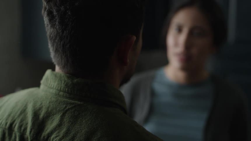 A view from behind shows a latino man arguing with a woman in a kitchen, then the woman leaves in frustration