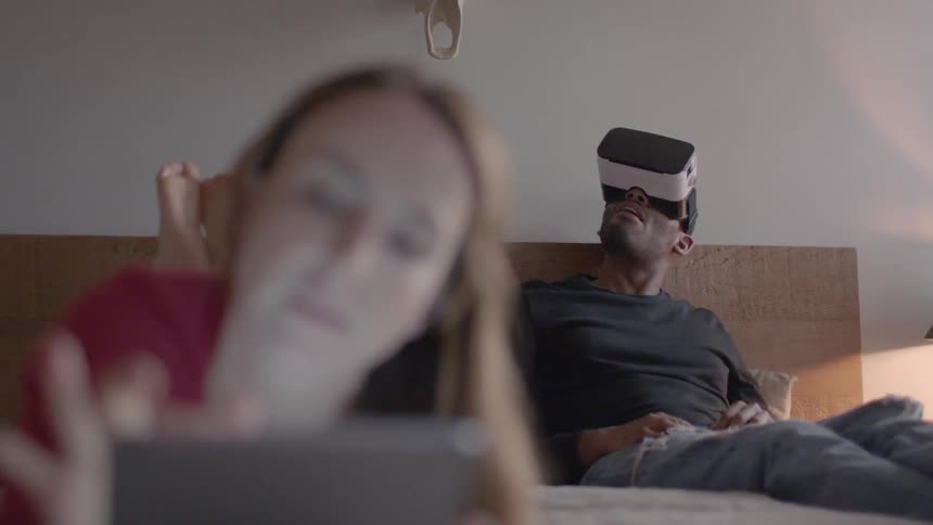 A man uses a vr headset and gets startled